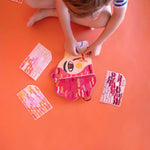 Child playing with colorful lion mask by Londji