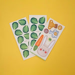 Londji three sheets of wooden cut out figures with green leaf patterns and a cartoon rabbit design on a yellow background.