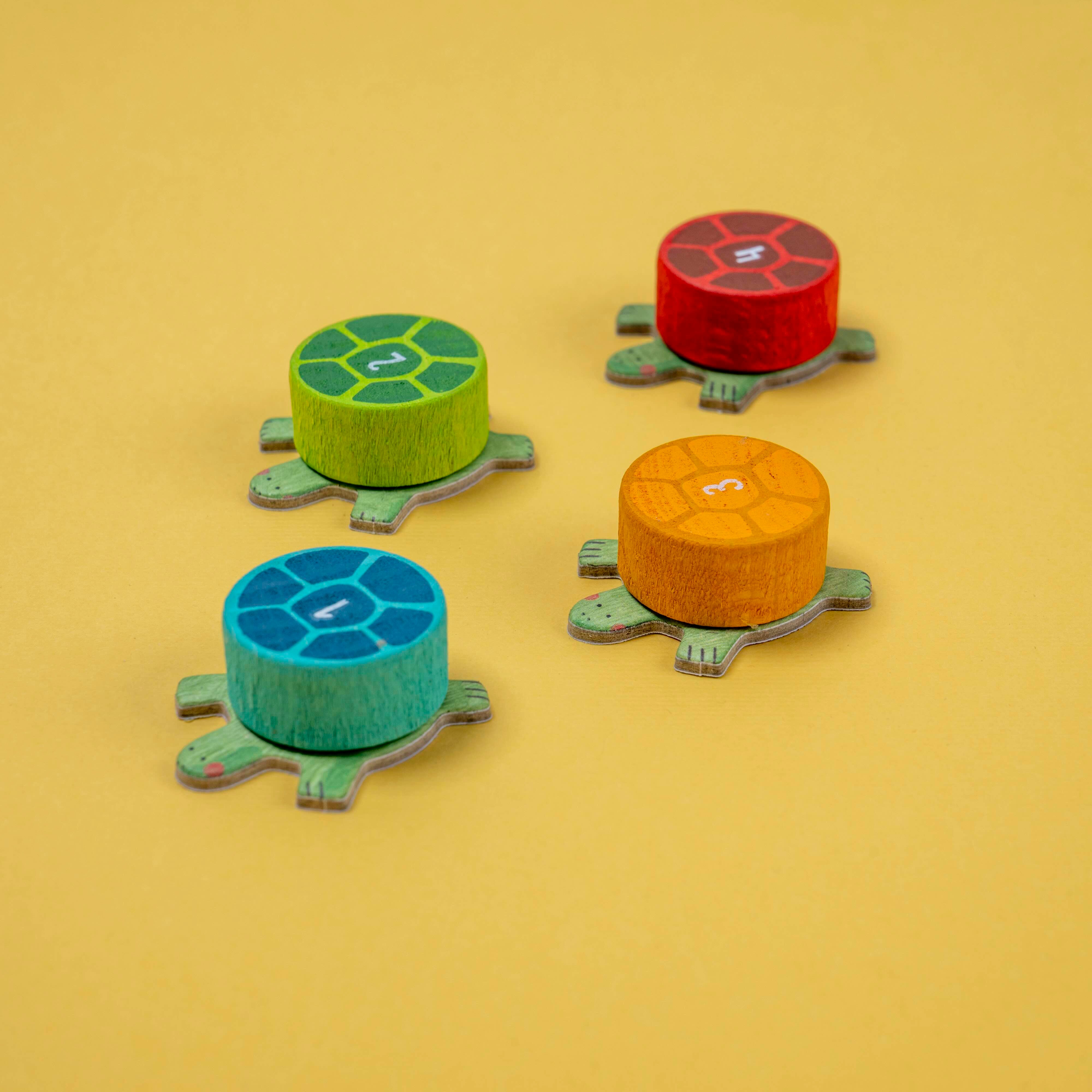 Londji four colorful turtle-shaped wooden pieces on a yellow background