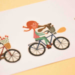Londji tattoos of a girl riding a bike with a dog on a white background