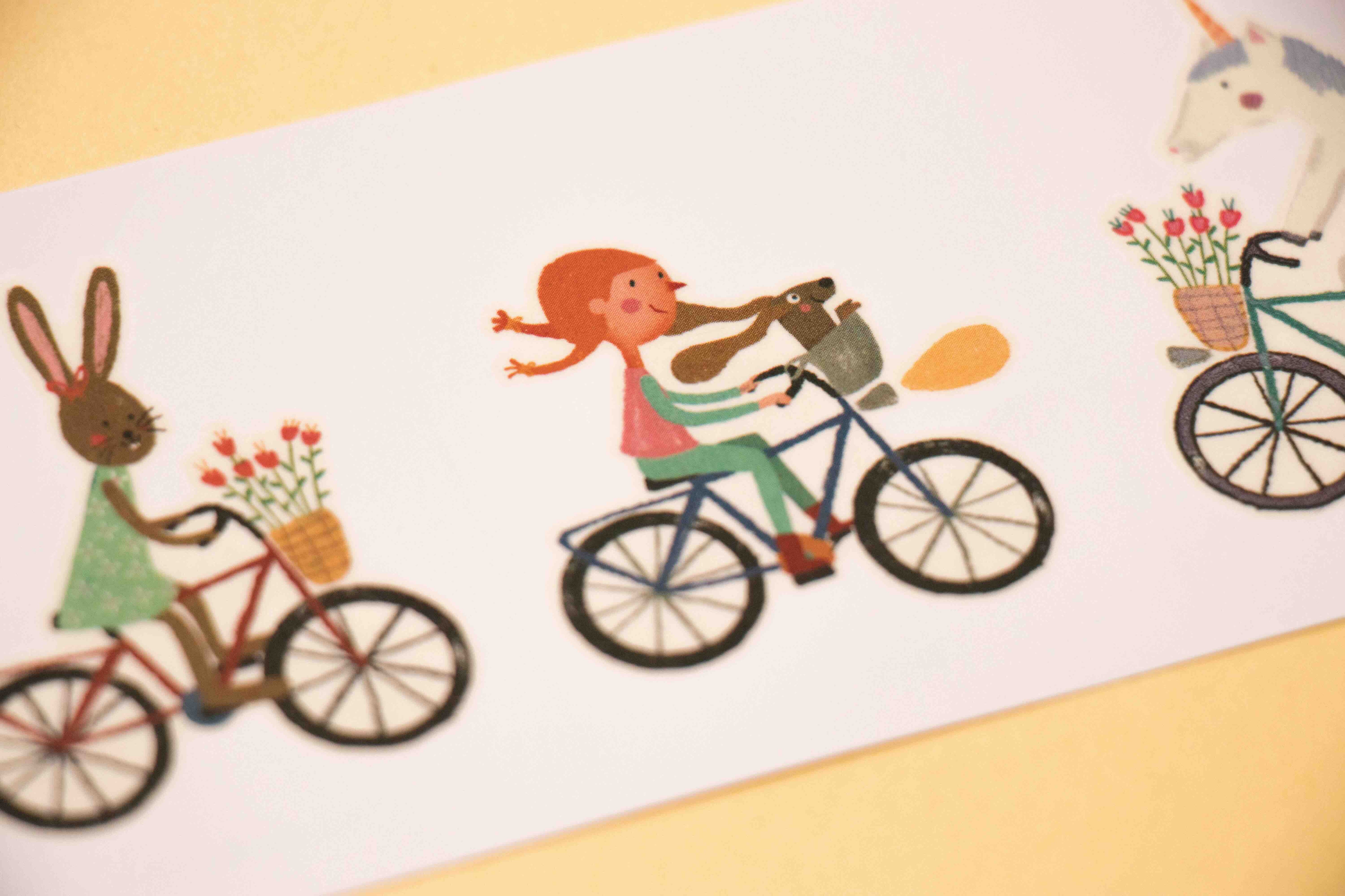 Londji tattoos of a girl riding a bike with a dog on a white background