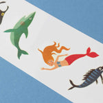 Londji colorful tattoos illustrations of a mermaid and fish on a blue and white striped background