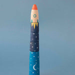 Londji toy rocket shaped with a blue body and red top on a gray background