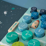 Londji children's educational board game with numbered wooden pieces and space-themed illustrations on a blue background