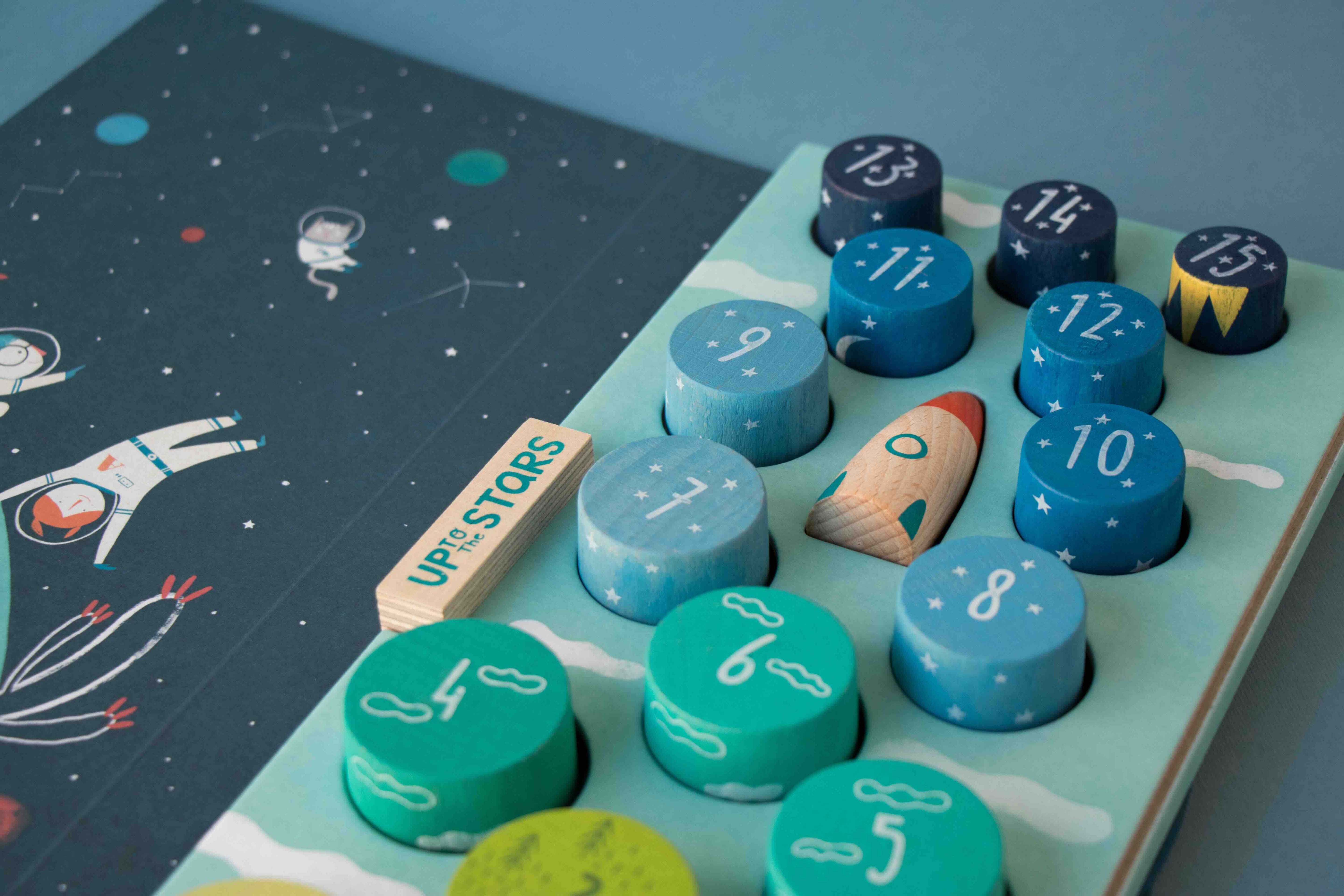 Londji children's educational board game with numbered wooden pieces and space-themed illustrations on a blue background