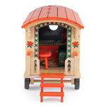 Moulin Roty wooden playhouse with red roof and steps on a white background