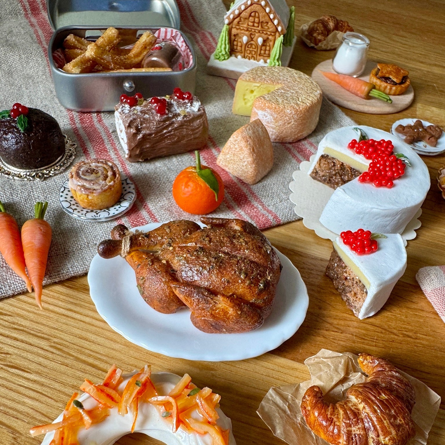 Assorted baked goods including cakes, pastries, and a roasted chicken on a wooden table.