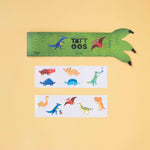 Londji tattoo sheet with dinosaur designs and green claw on a yellow background