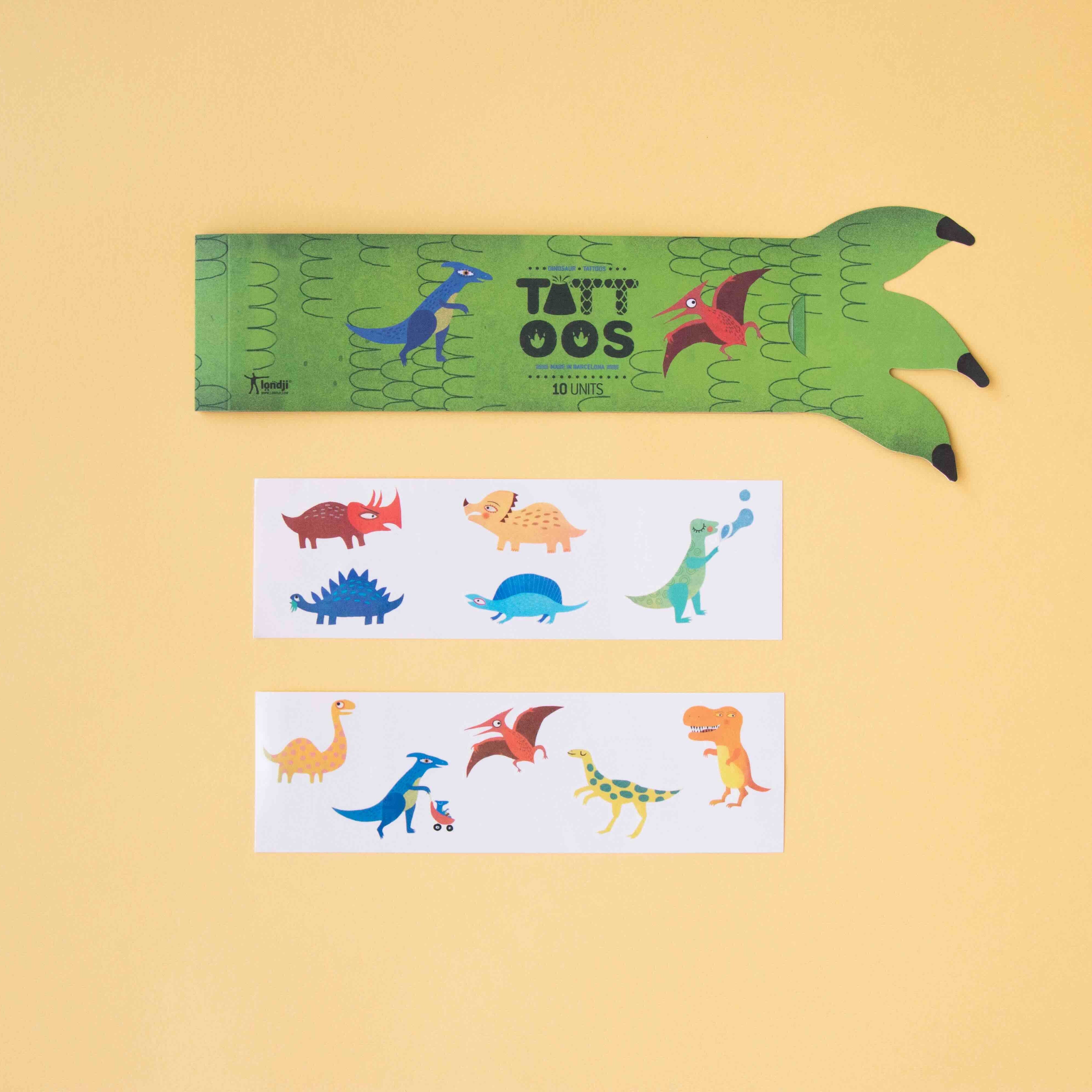Londji tattoo sheet with dinosaur designs and green claw on a yellow background