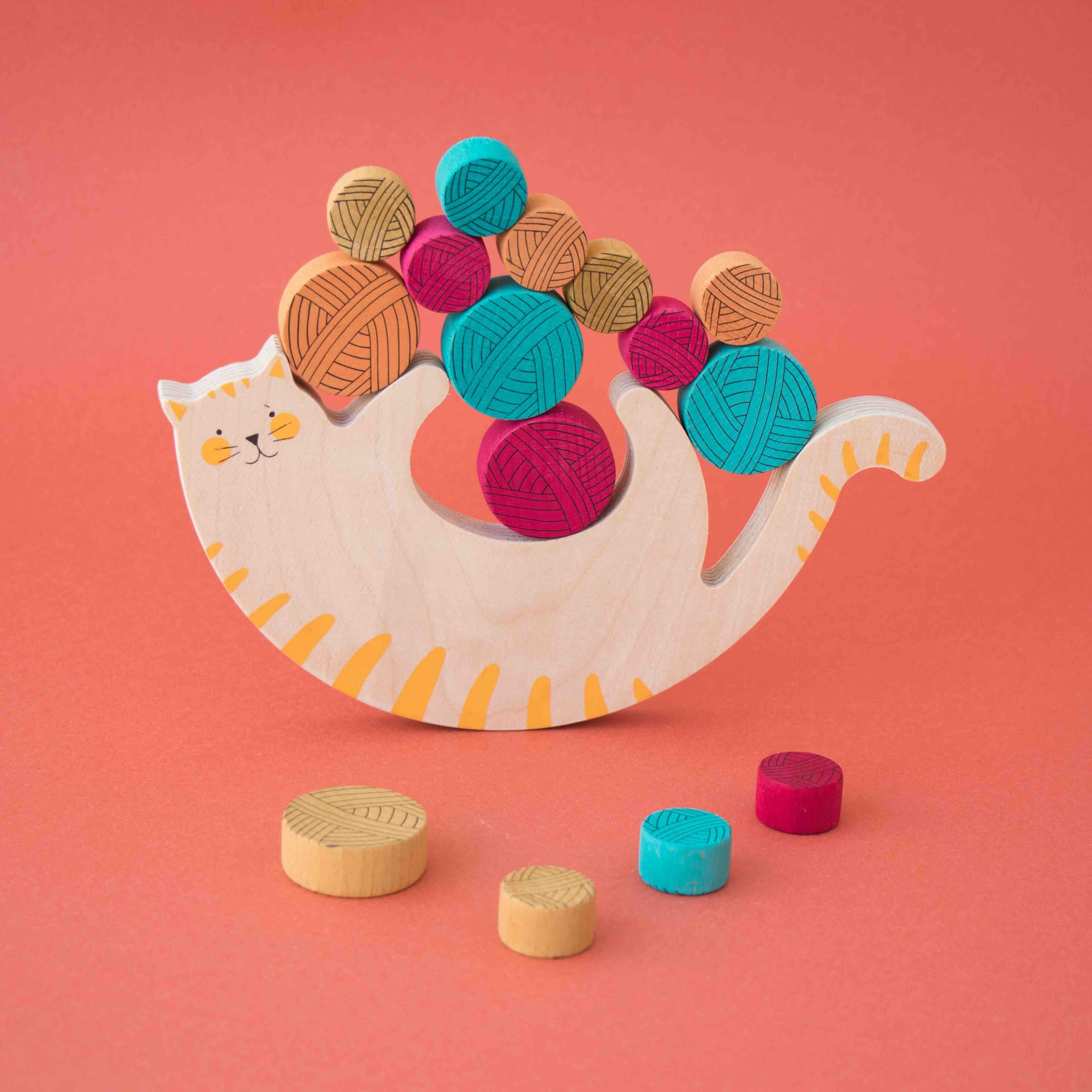 Londji meow wooden toy cat with colorful wooden blocks on a pink background