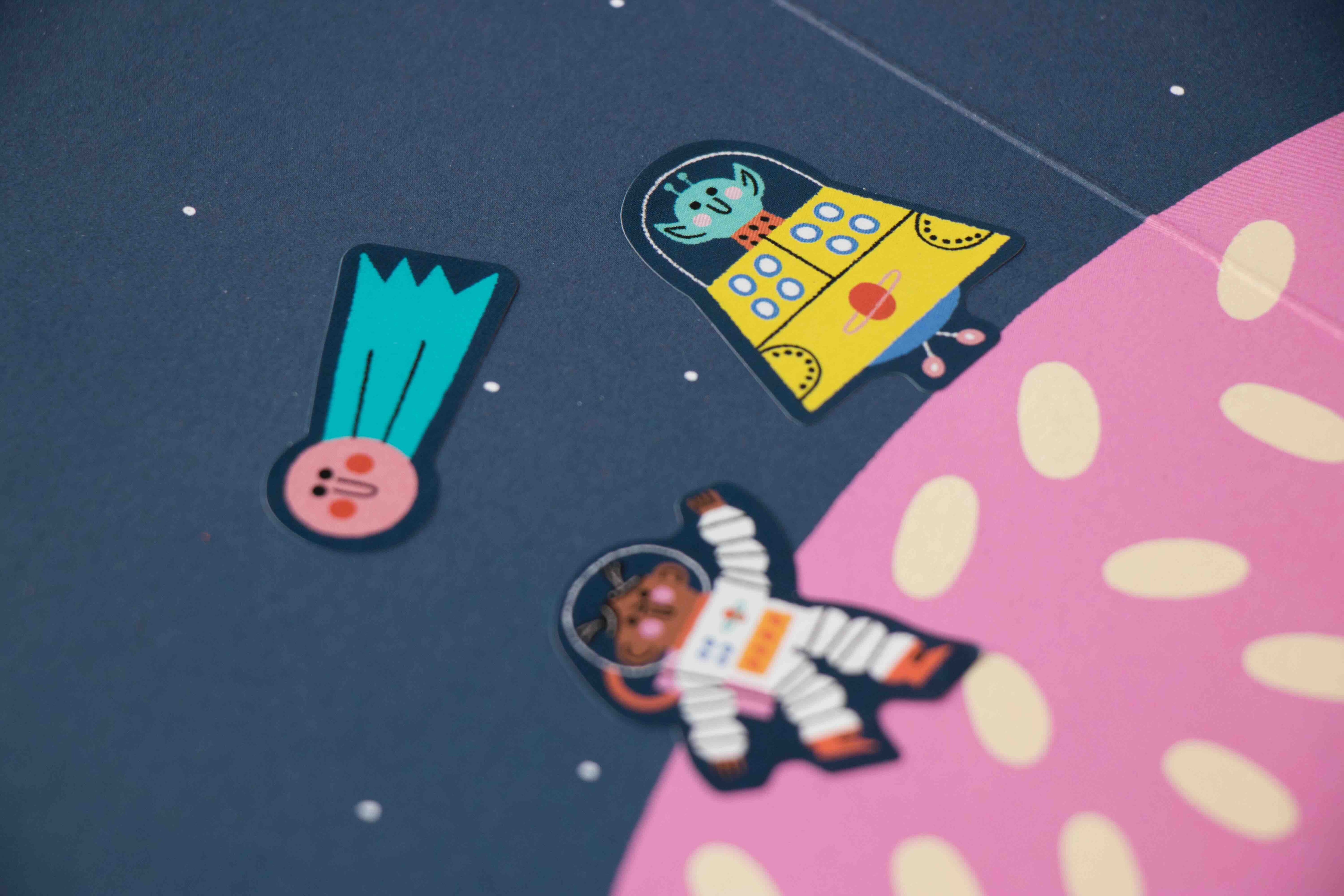 Londji colorful space-themed stickers on a pink and blue background