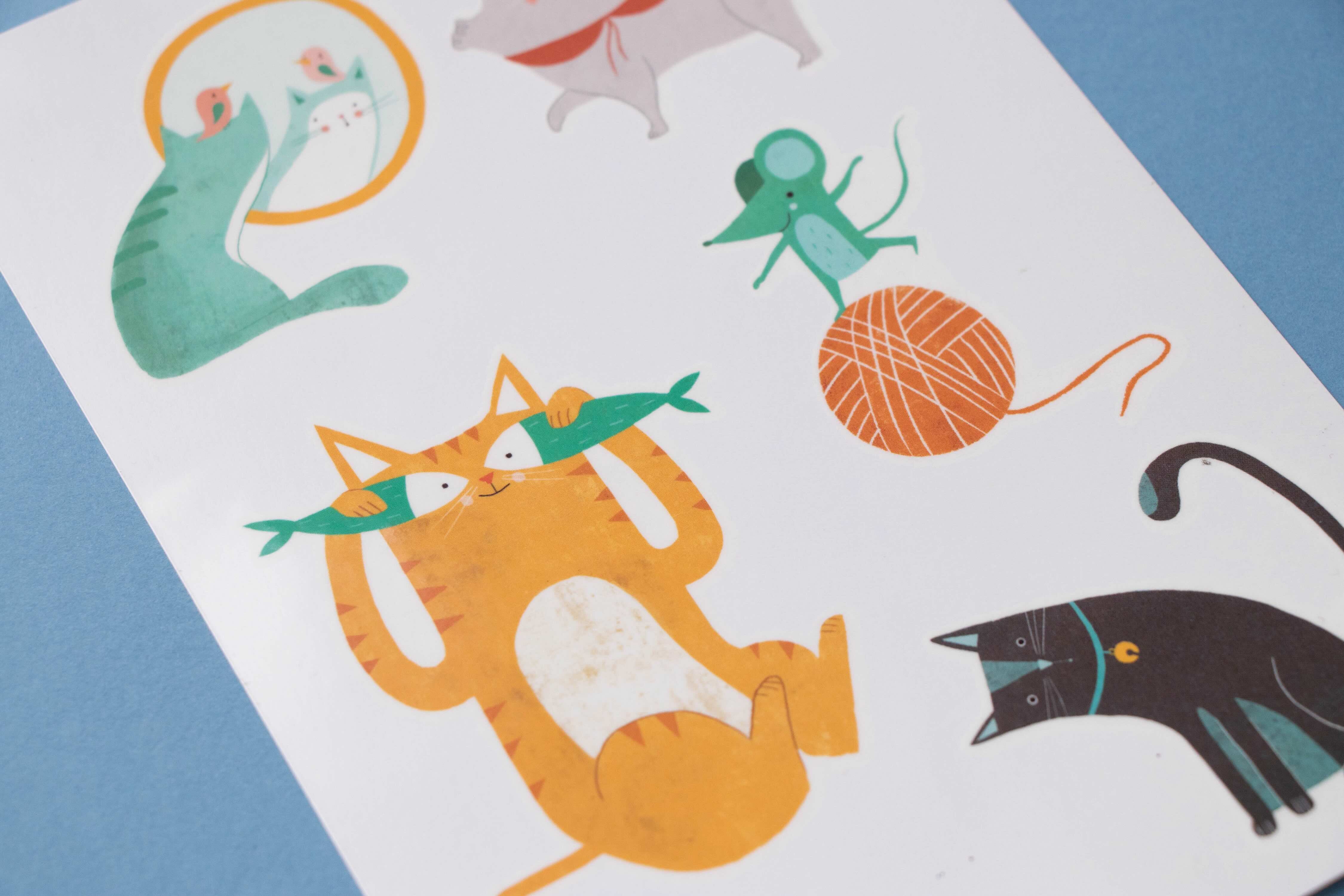 Londji sheet of colorful cat-themed tattoos with various designs on a white background.