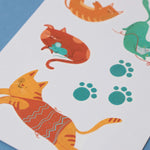 Londji colorful cat tattoos on a white sheet with blue background