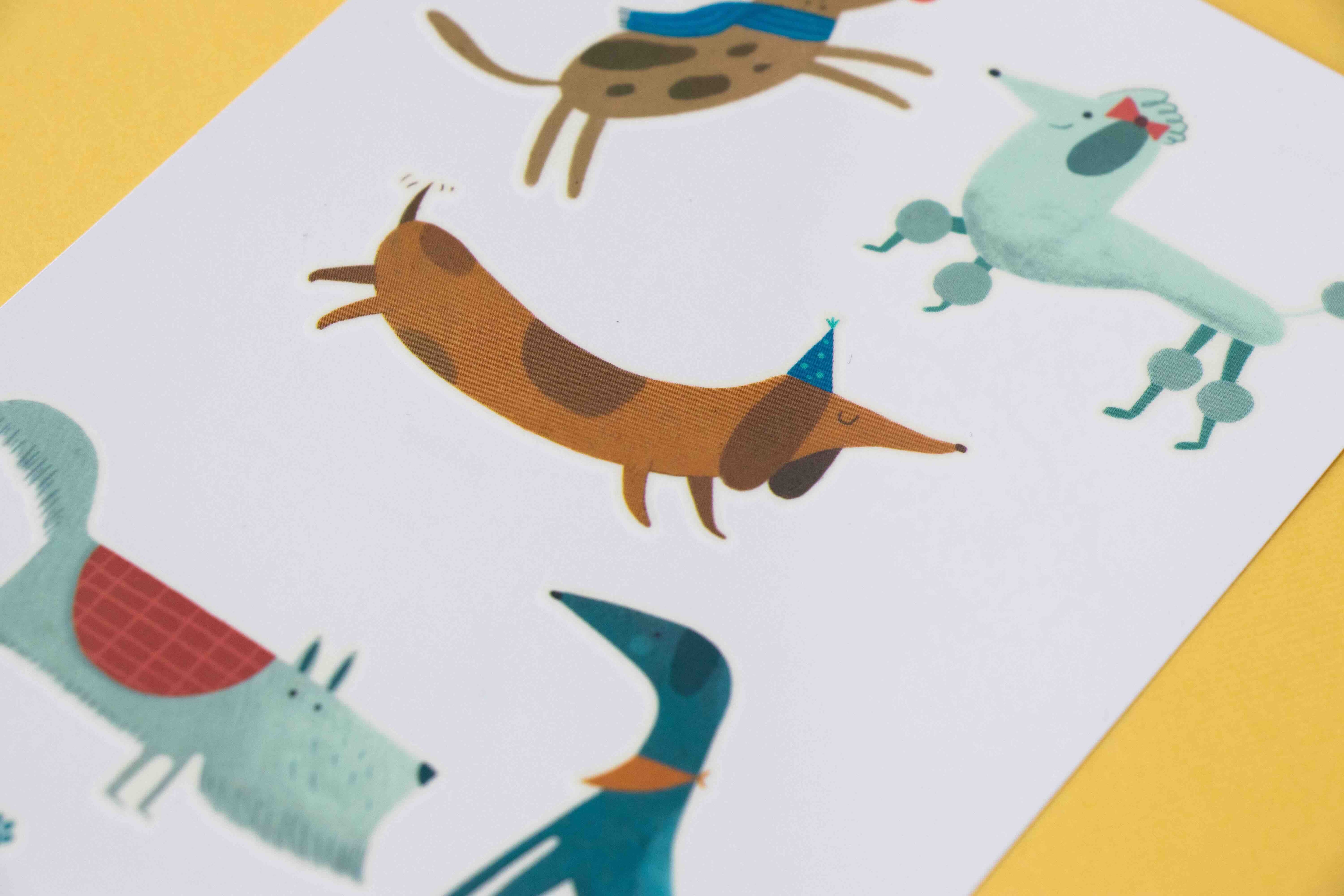 Londji tattoos of cartoon dogs on a white background with a yellow border