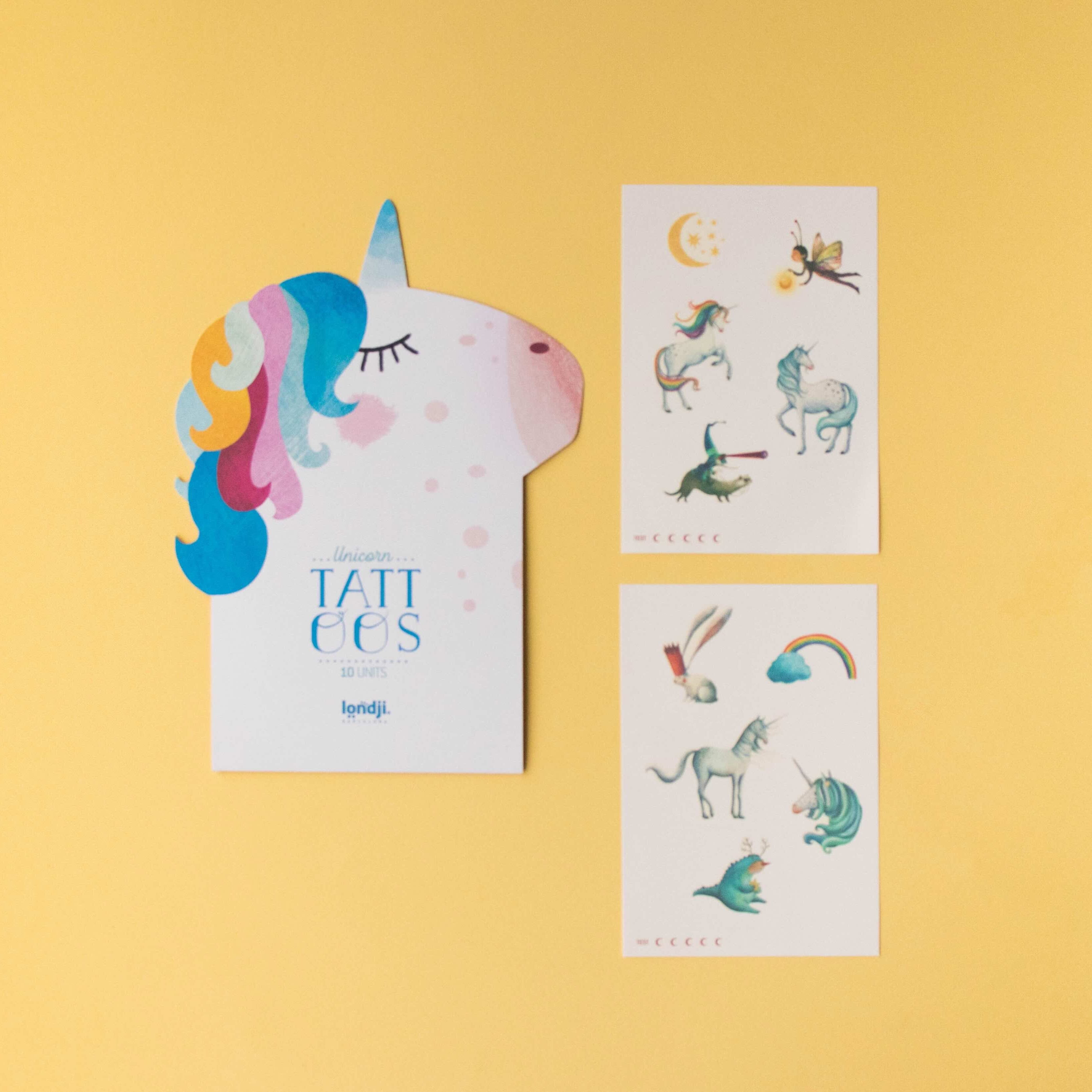 Londji unicorn-shaped card with small tattoo designs on a yellow background