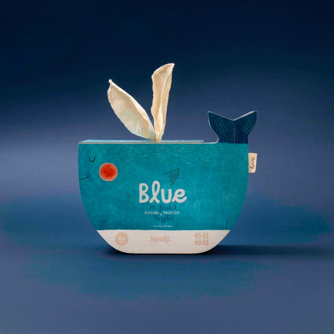Londji Blue whale-shaped puzzle with a label on a blue background