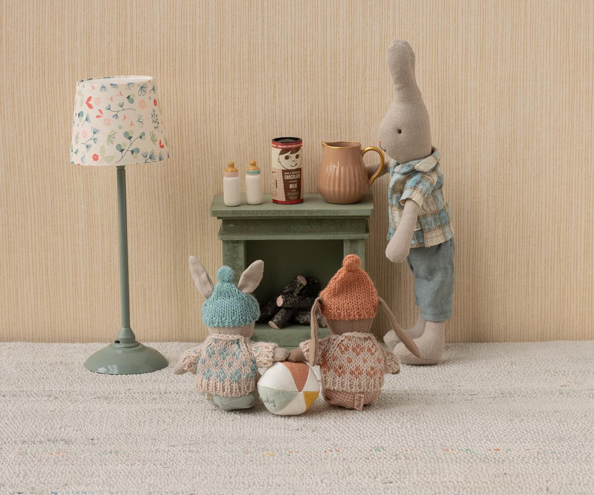 Maileg Winter Bunny Micro Brown & Rose sat around the Maileg fireplace with rabbit friends