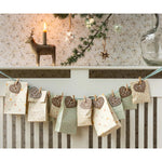 Decorative advent calendar with heart-shaped cookies on a wooden shelf.