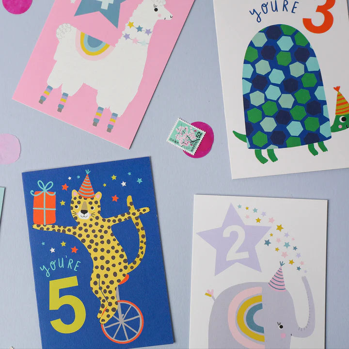 Mifkins collection of children's birthday cards with colourful illustrations on a light purple background.
