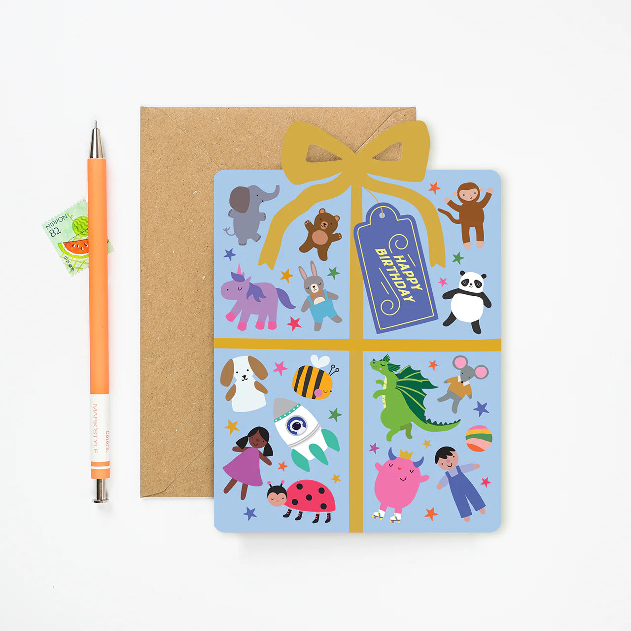 Mifkins children's birthday card with cartoon characters and a yellow ribbon, next to a pen on a white background.
