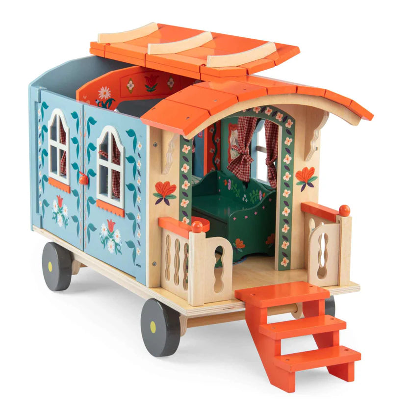 Moulin Roty colourful toy caravan with detailed interior on a white background