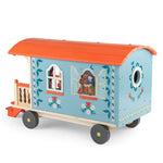 Moulin Roty toy caravan with decorative elements on a white background