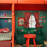 Moulin Roty toy caravan room with red bunk bed, green desk, and red stool.