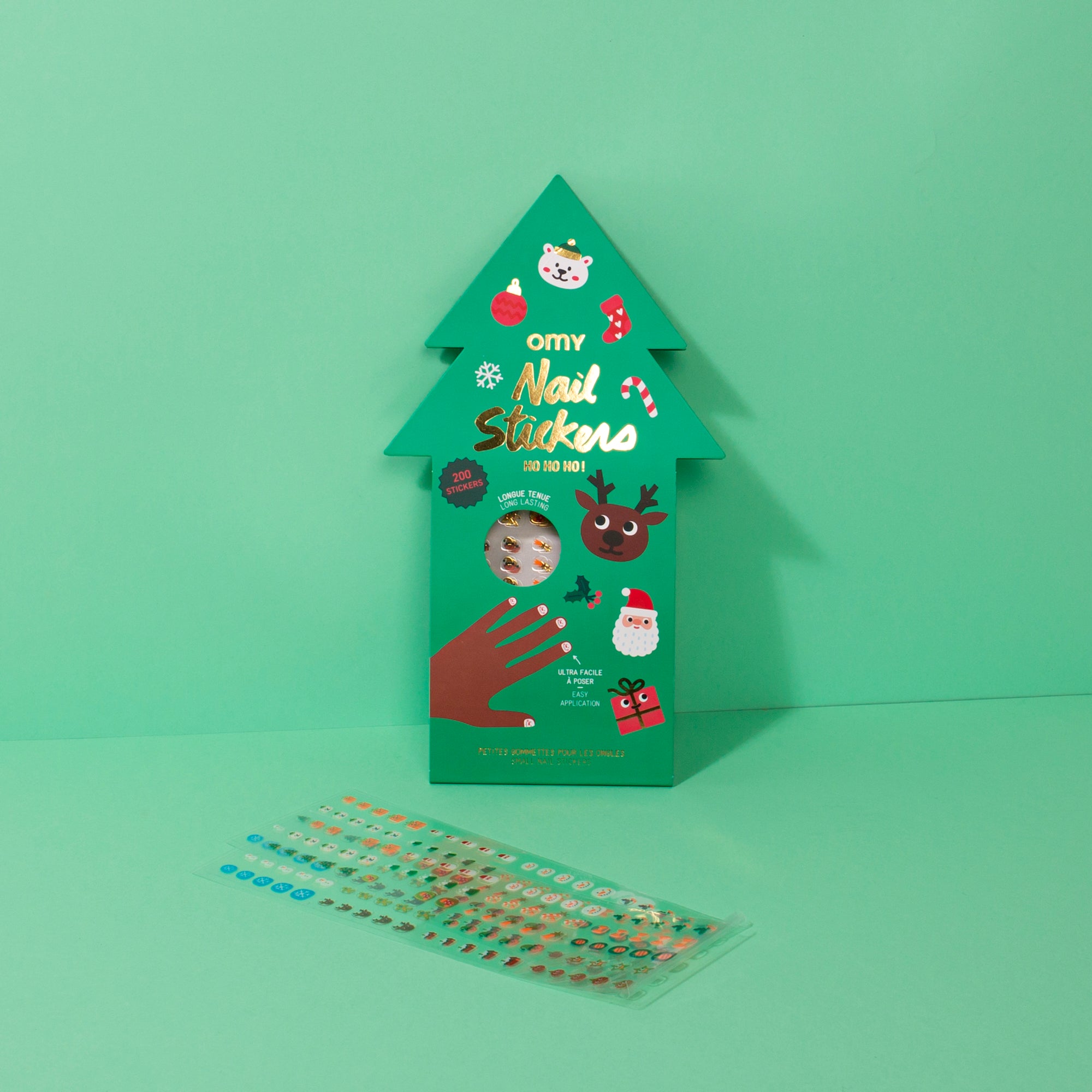 Green tree-shaped pack of OMY nail stickers with a sheet of stickers on a green background