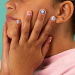 Close-up of a person with OMY nail stickers on their fingers against a teal background