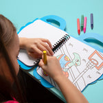 Child coloring an OMY picture of a turtle with markers on a blue table.