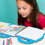 Young girl coloring in an OMY book with crayons on a light blue background