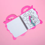 OMY coloring book with a pink holder on a pink background