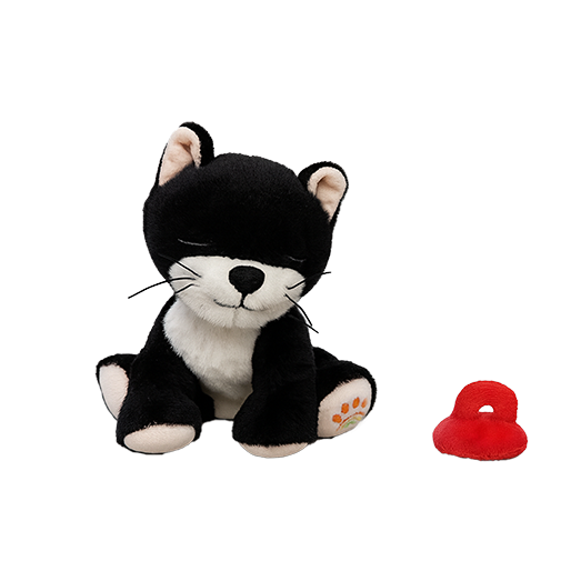 Black and white plush toy cat with a red object on a white background