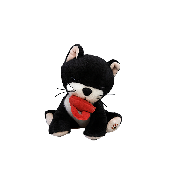 Black and white plush toy with a red heart on a white background